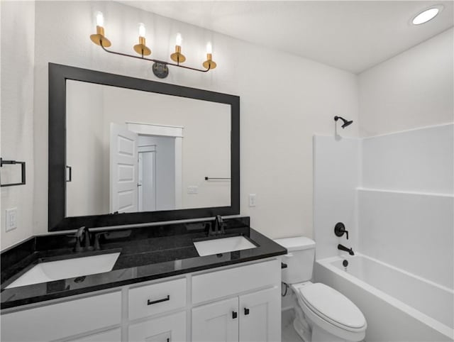 full bathroom with vanity, toilet, and washtub / shower combination