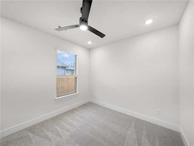 carpeted spare room featuring ceiling fan