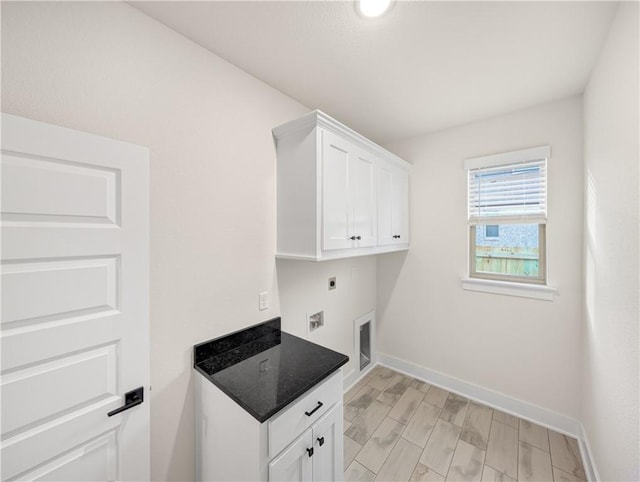 washroom featuring light wood-type flooring, cabinets, and electric dryer hookup