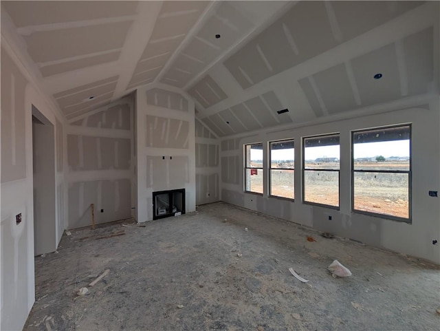 unfurnished living room featuring lofted ceiling