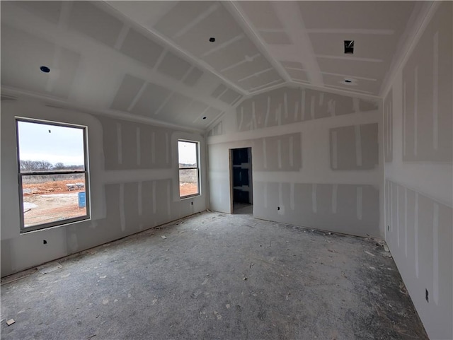 unfurnished room with lofted ceiling