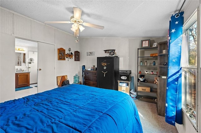 bedroom featuring ceiling fan, light colored carpet, and a textured ceiling