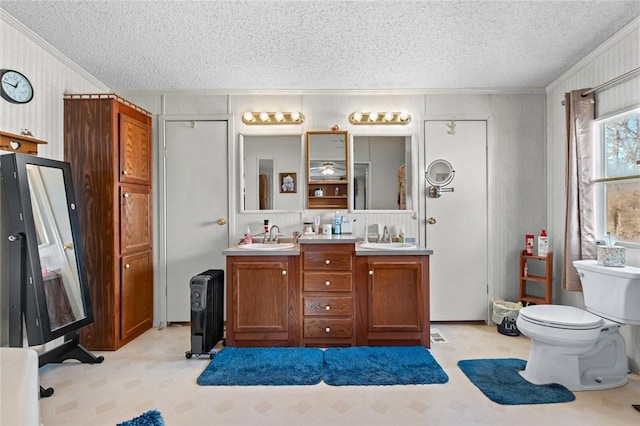 bathroom with vanity, a textured ceiling, toilet, and ornamental molding