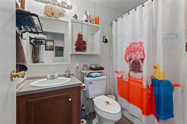 bathroom featuring a shower with curtain, vanity, a textured ceiling, and toilet