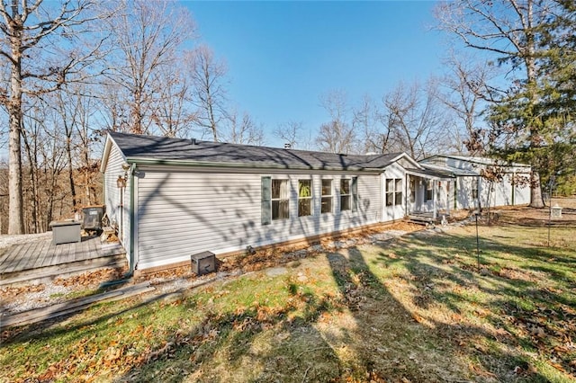 back of house featuring a yard and a deck