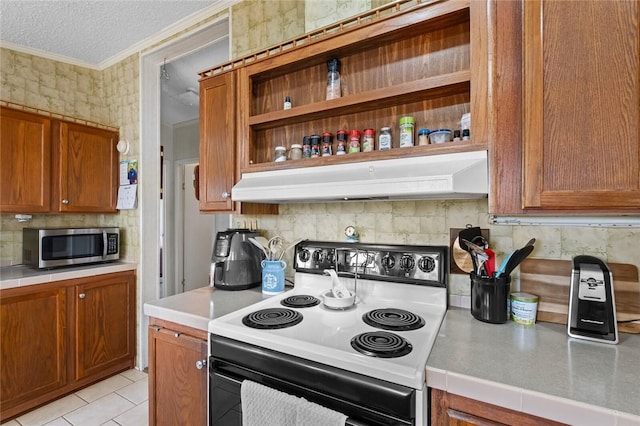 kitchen with light tile patterned flooring, a textured ceiling, and electric stove