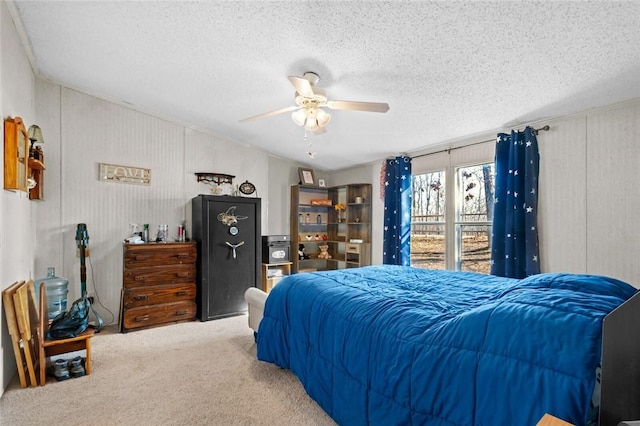 carpeted bedroom with ceiling fan and a textured ceiling