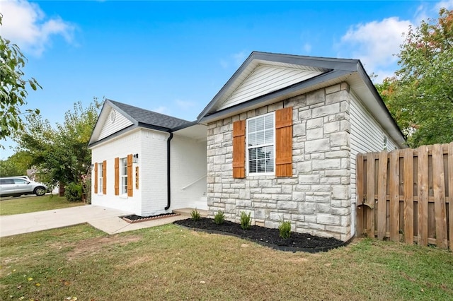 view of side of home with a lawn