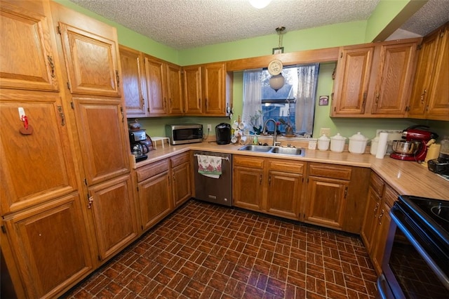 kitchen with sink, stainless steel appliances, and a textured ceiling