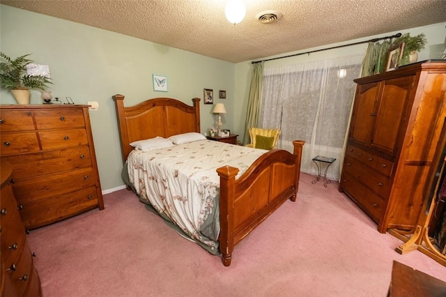 bedroom featuring light colored carpet and a textured ceiling