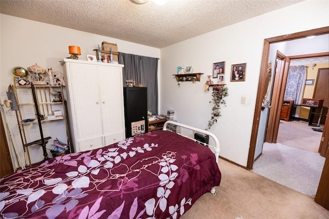 bedroom with light carpet and a textured ceiling