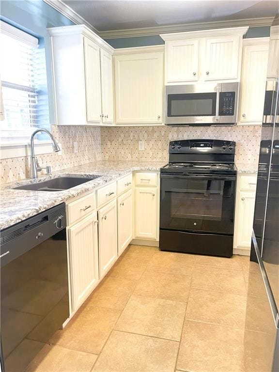 kitchen with black appliances, crown molding, sink, light stone countertops, and tasteful backsplash