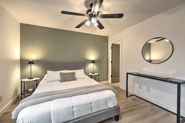 bedroom with ceiling fan and light wood-type flooring