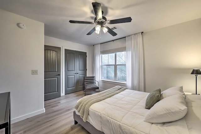 bedroom with ceiling fan and light hardwood / wood-style floors