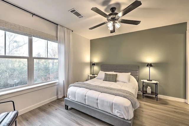 bedroom featuring light hardwood / wood-style flooring and ceiling fan