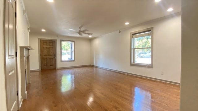 empty room with plenty of natural light, ceiling fan, and ornamental molding