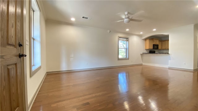 unfurnished living room featuring ceiling fan and wood-type flooring