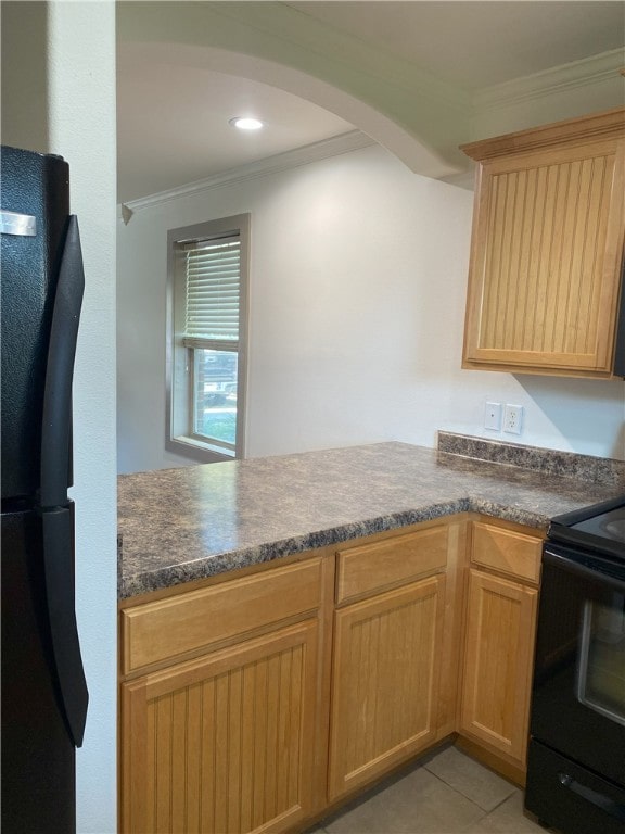 kitchen featuring light tile patterned floors, ornamental molding, and black appliances