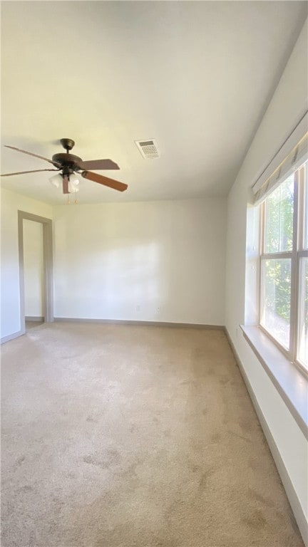 carpeted empty room with ceiling fan