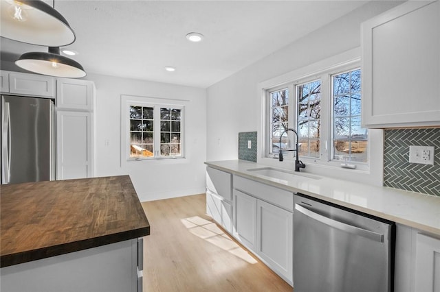 kitchen featuring sink, white cabinetry, and appliances with stainless steel finishes