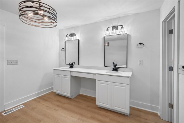 bathroom featuring hardwood / wood-style flooring and vanity