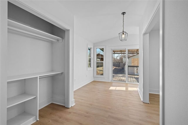 interior space featuring light hardwood / wood-style floors and lofted ceiling