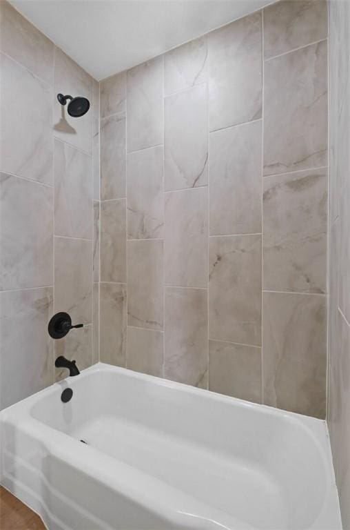 bathroom featuring tiled shower / bath combo and hardwood / wood-style floors