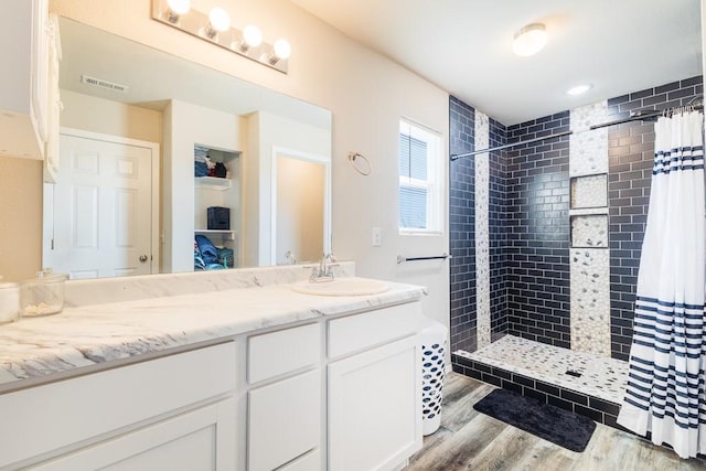 bathroom featuring vanity, curtained shower, and wood-type flooring