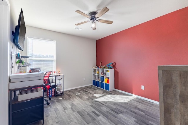 interior space featuring wood-type flooring and ceiling fan