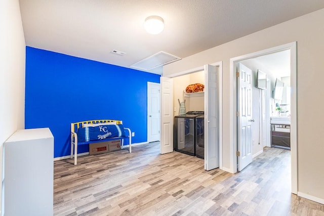 interior space featuring light wood-type flooring and separate washer and dryer