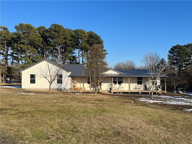 rear view of house with a wooden deck and a lawn