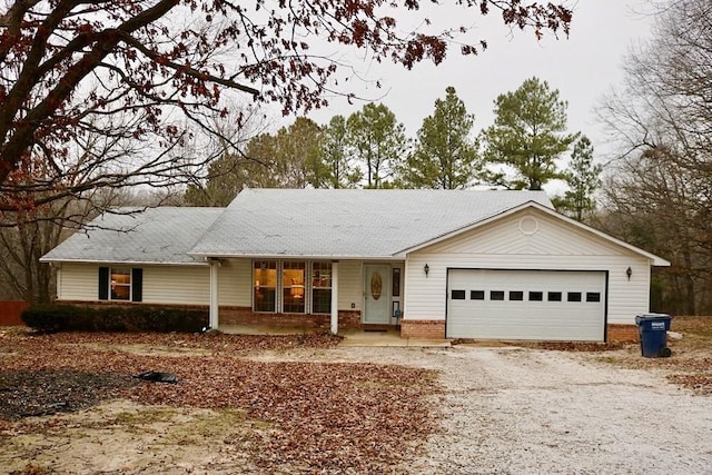 single story home with a porch and a garage