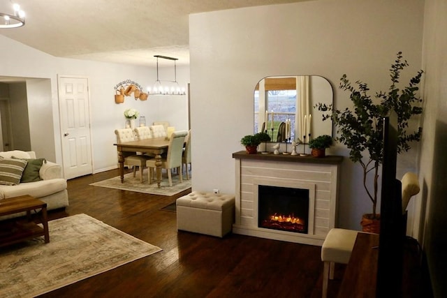 living room featuring dark hardwood / wood-style floors and an inviting chandelier