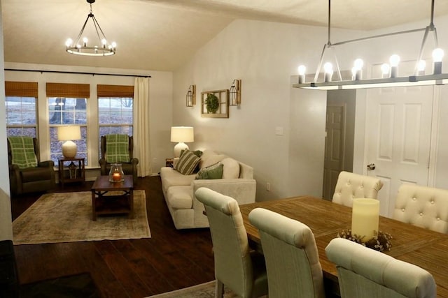 dining area with dark hardwood / wood-style flooring, vaulted ceiling, and an inviting chandelier