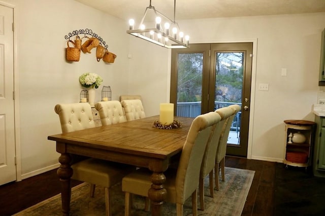 dining room with plenty of natural light, dark hardwood / wood-style floors, and an inviting chandelier