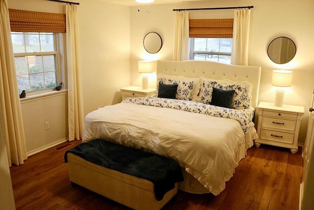 bedroom with dark hardwood / wood-style flooring