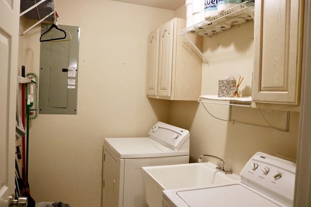 washroom with cabinets, electric panel, and washing machine and clothes dryer