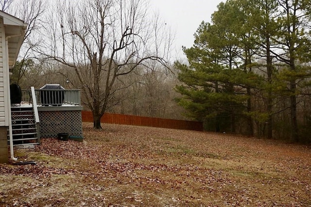 view of yard featuring cooling unit and a wooden deck