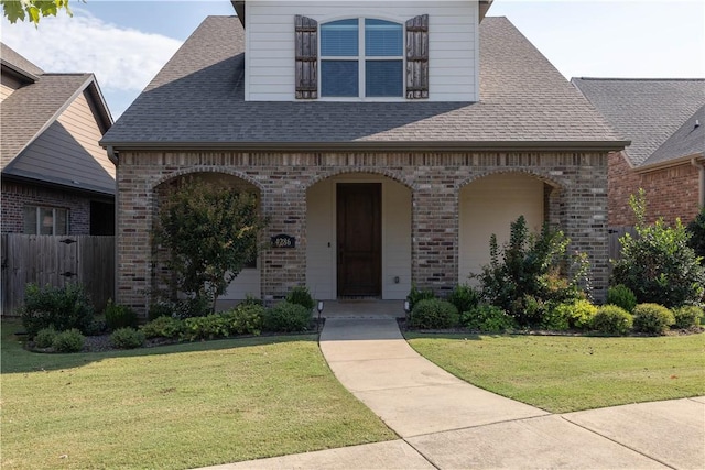 view of front of home with a porch and a front lawn