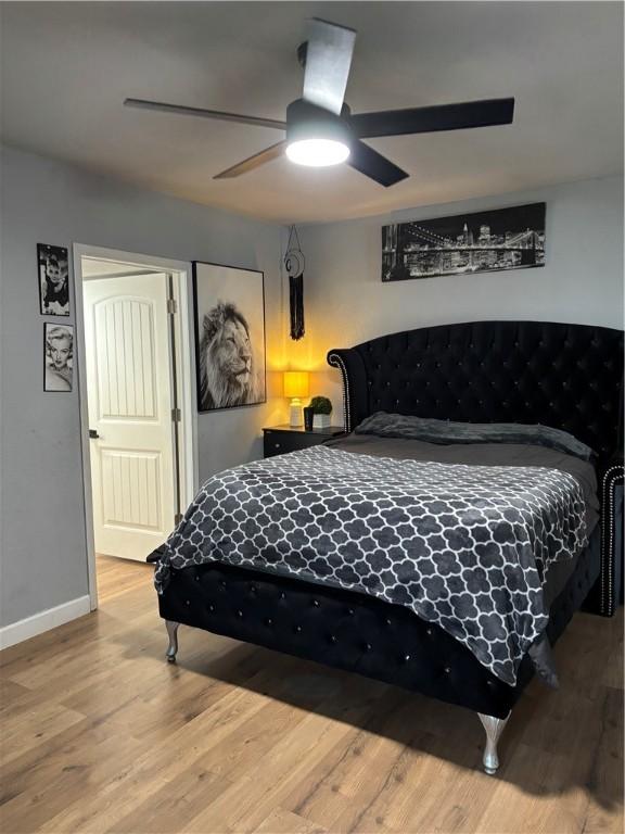 bedroom with ceiling fan and wood-type flooring