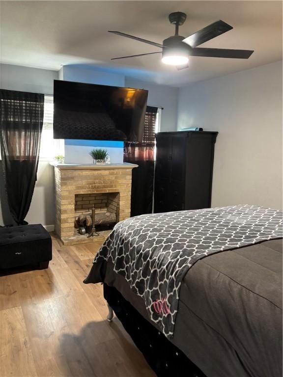 bedroom with light hardwood / wood-style flooring and ceiling fan