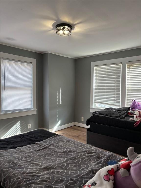 bedroom featuring hardwood / wood-style flooring and ornamental molding