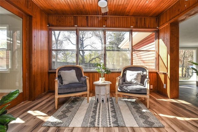 sunroom / solarium featuring ceiling fan and wood ceiling