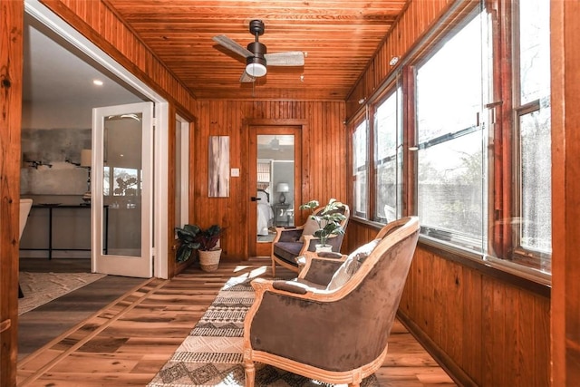 sunroom featuring ceiling fan and wood ceiling