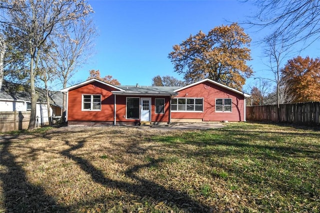 back of property with a lawn