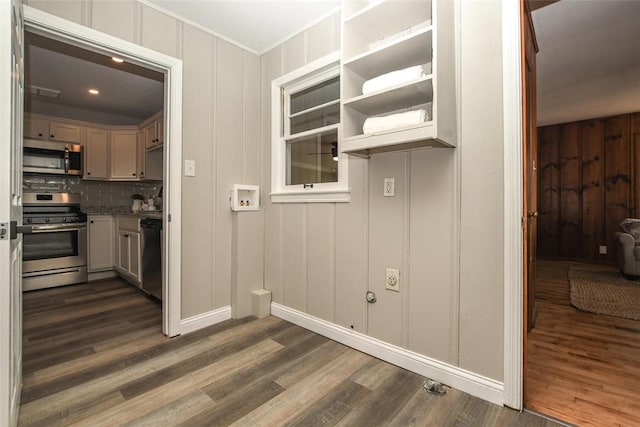 kitchen with tasteful backsplash, stainless steel appliances, and dark hardwood / wood-style floors