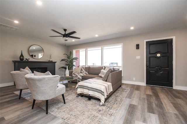 living room featuring hardwood / wood-style floors and ceiling fan