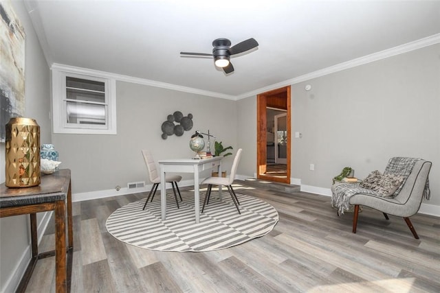 office with wood-type flooring, ceiling fan, and crown molding