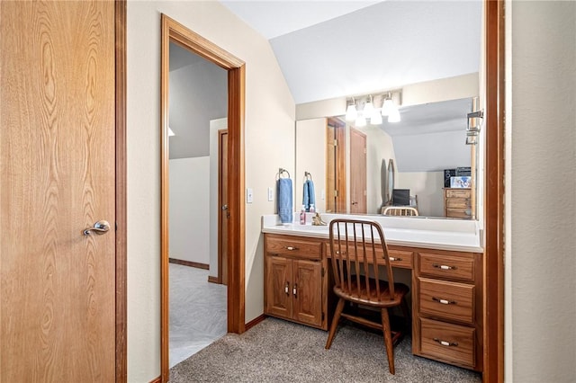 bathroom with lofted ceiling and vanity