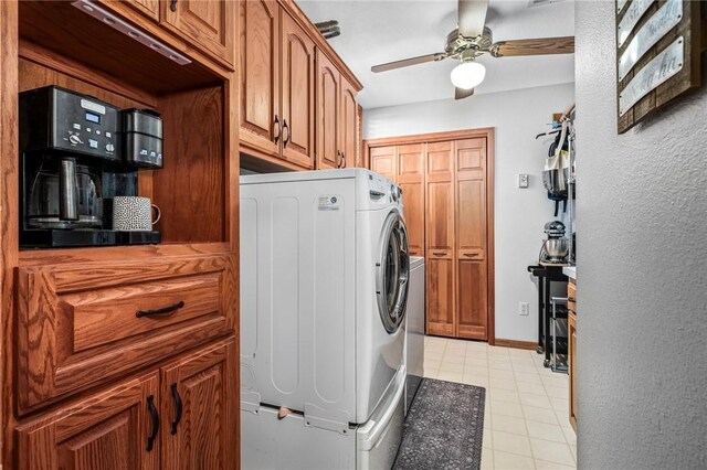 laundry room with ceiling fan, cabinets, and washer / clothes dryer